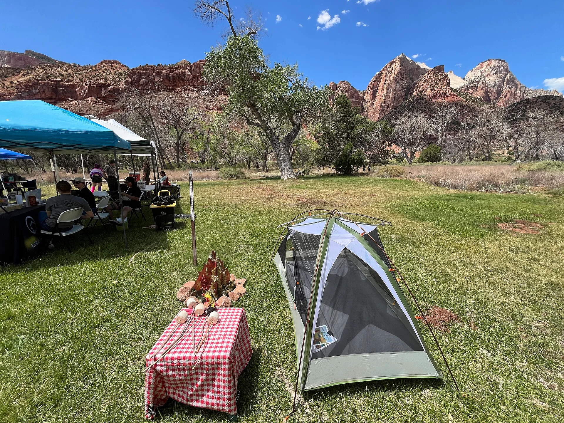 Side view of our rustic-themed photo op area from the BLM Pride event, featuring a tent, artificial fire, and picnic table setup. Photo by Melissa Buchmann BLM Utah. Site survey before a party rental quote: six questions that set labor