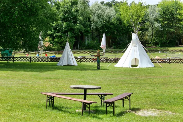 leisure facility, tipi, time, indian, warehouse, nature, indian tent, culture, summer, landscape, table, benches, trees, grass. Party Rental Winter Storage Tips for Tents and Inflatables